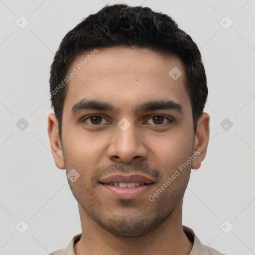 Joyful latino young-adult male with short  black hair and brown eyes