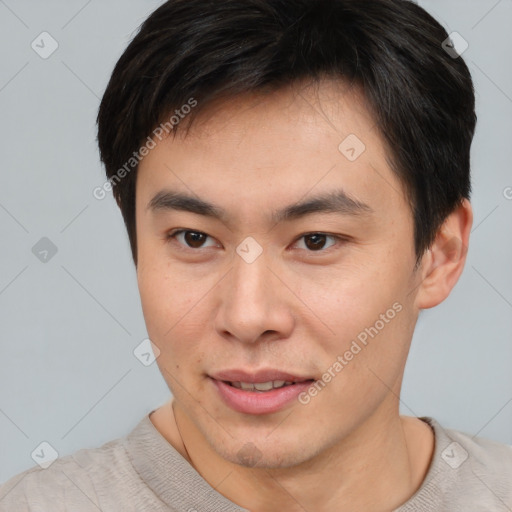 Joyful asian young-adult male with short  brown hair and brown eyes
