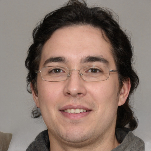 Joyful white adult male with medium  brown hair and brown eyes