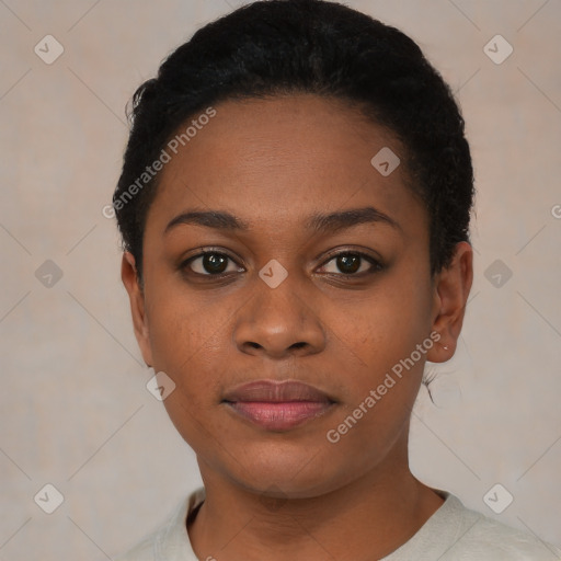 Joyful black young-adult female with short  black hair and brown eyes