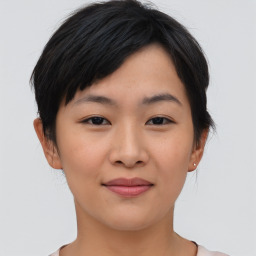 Joyful asian young-adult female with short  black hair and brown eyes