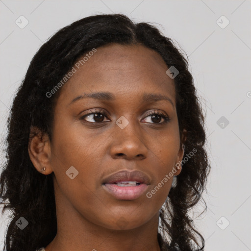 Joyful black young-adult female with long  brown hair and brown eyes