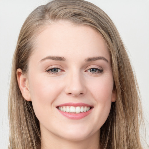 Joyful white young-adult female with long  brown hair and grey eyes