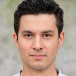 Joyful white young-adult male with short  black hair and brown eyes