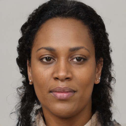 Neutral black young-adult female with long  brown hair and brown eyes