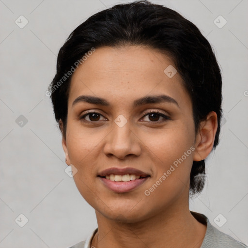 Joyful latino young-adult female with short  black hair and brown eyes