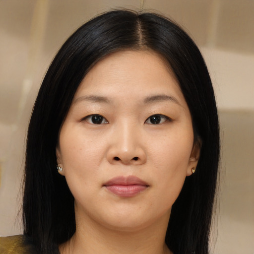 Joyful asian young-adult female with long  brown hair and brown eyes