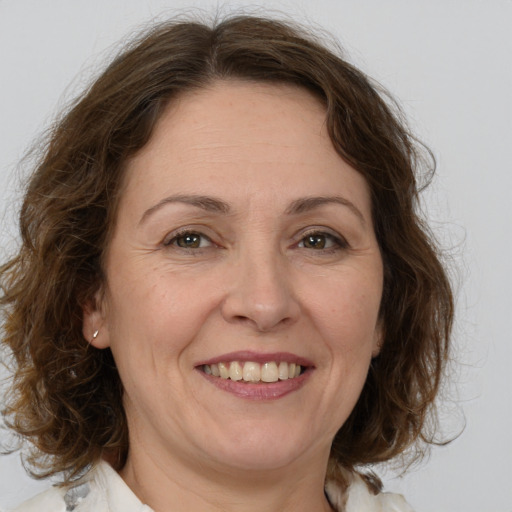 Joyful white adult female with medium  brown hair and brown eyes