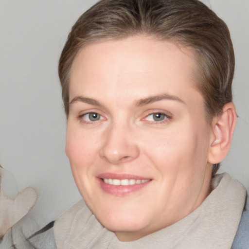 Joyful white adult female with medium  brown hair and grey eyes