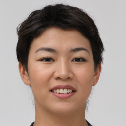 Joyful asian young-adult female with short  brown hair and brown eyes