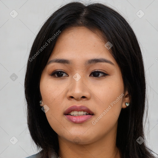 Joyful asian young-adult female with long  black hair and brown eyes