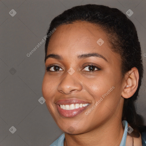 Joyful black young-adult female with short  black hair and brown eyes