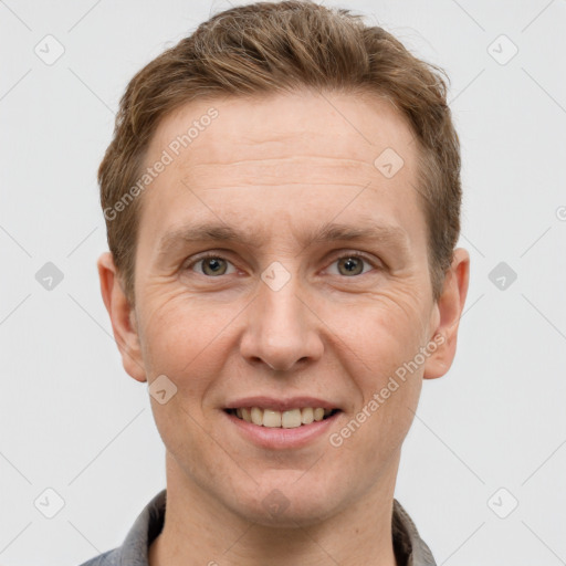 Joyful white adult male with short  brown hair and grey eyes