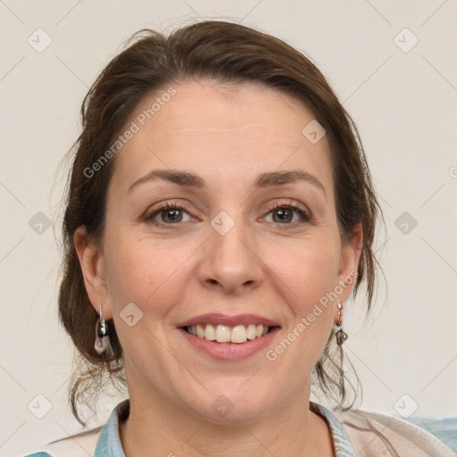 Joyful white adult female with medium  brown hair and grey eyes