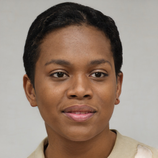 Joyful black young-adult female with short  brown hair and brown eyes