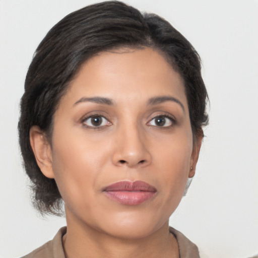 Joyful latino young-adult female with medium  brown hair and brown eyes