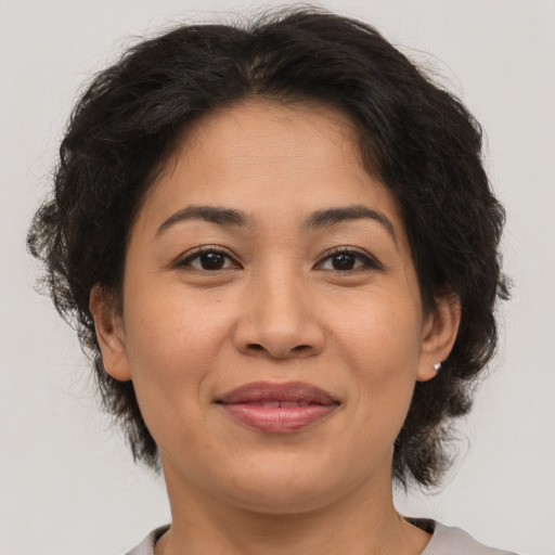 Joyful asian adult female with medium  brown hair and brown eyes