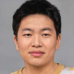 Joyful asian young-adult male with short  brown hair and brown eyes