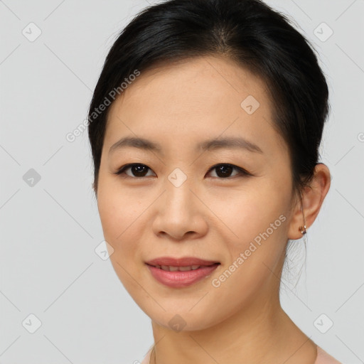 Joyful asian young-adult female with medium  brown hair and brown eyes