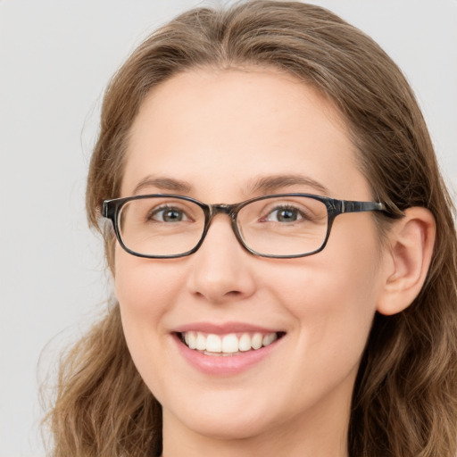 Joyful white young-adult female with long  brown hair and blue eyes