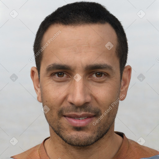 Joyful white young-adult male with short  black hair and brown eyes