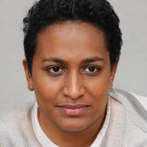 Joyful black young-adult female with short  brown hair and brown eyes