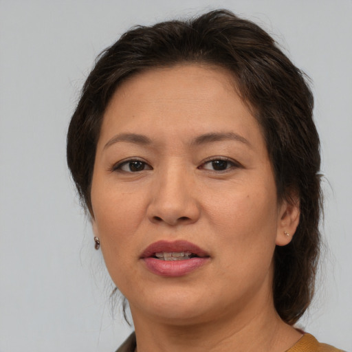 Joyful asian adult female with medium  brown hair and brown eyes