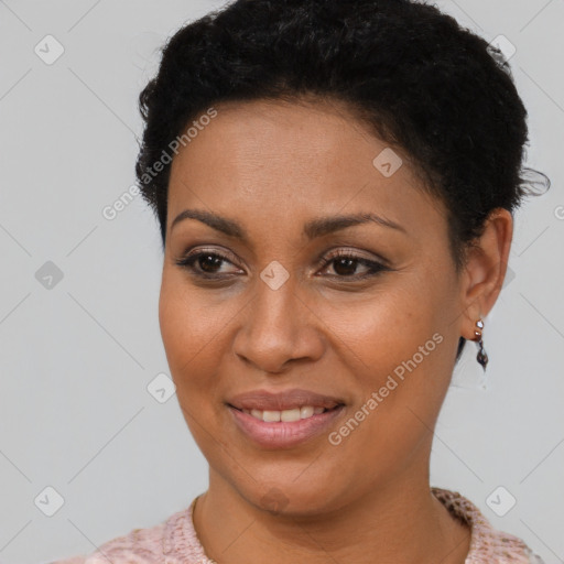 Joyful black young-adult female with short  black hair and brown eyes