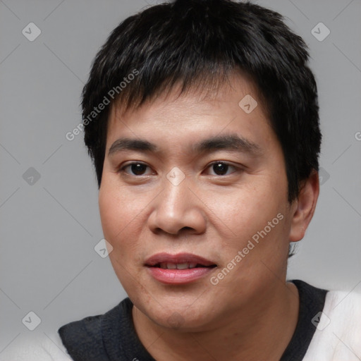 Joyful asian young-adult male with short  black hair and brown eyes