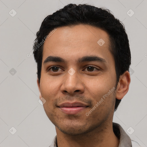 Joyful latino young-adult male with short  black hair and brown eyes