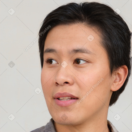 Joyful asian young-adult male with medium  brown hair and brown eyes