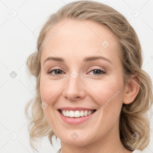 Joyful white young-adult female with medium  brown hair and blue eyes