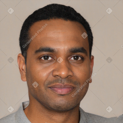 Joyful black young-adult male with short  black hair and brown eyes