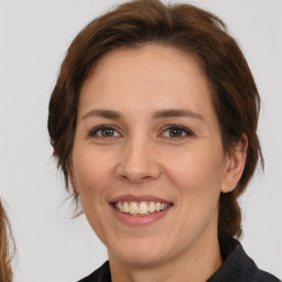 Joyful white adult female with medium  brown hair and brown eyes