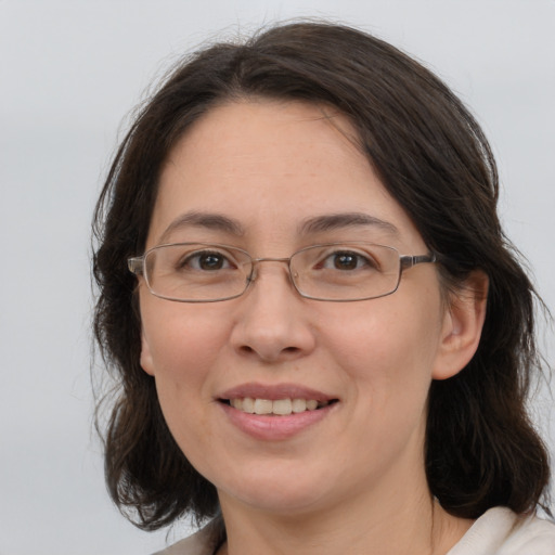 Joyful white adult female with medium  brown hair and brown eyes