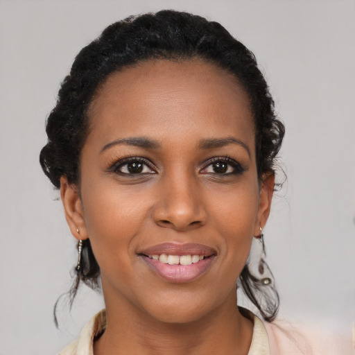 Joyful black young-adult female with medium  black hair and brown eyes