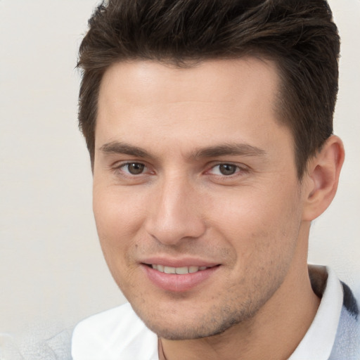 Joyful white young-adult male with short  brown hair and brown eyes