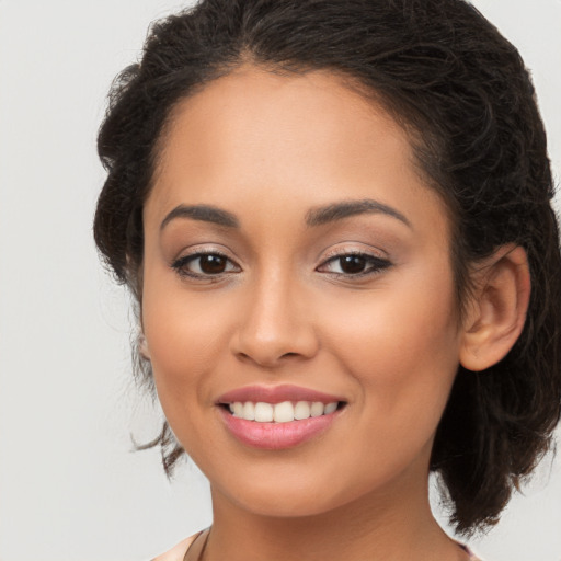 Joyful latino young-adult female with long  brown hair and brown eyes