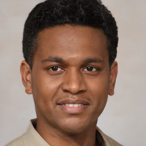 Joyful latino young-adult male with short  brown hair and brown eyes