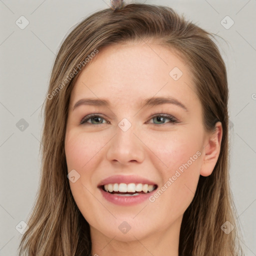 Joyful white young-adult female with long  brown hair and grey eyes