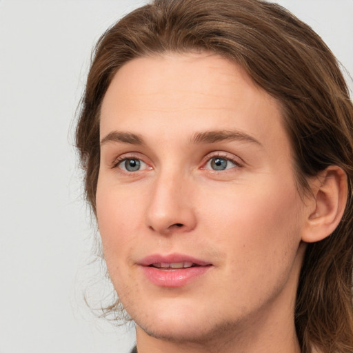 Joyful white young-adult female with long  brown hair and grey eyes