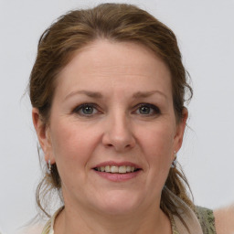 Joyful white adult female with medium  brown hair and grey eyes