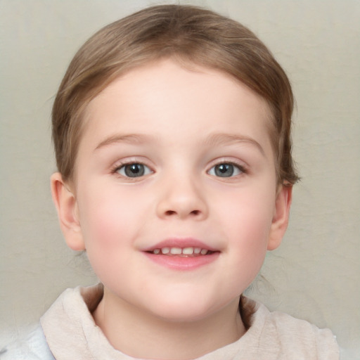 Joyful white child female with short  brown hair and blue eyes