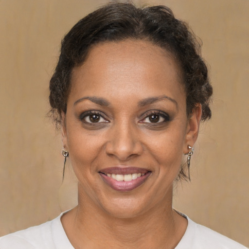 Joyful black adult female with short  brown hair and brown eyes