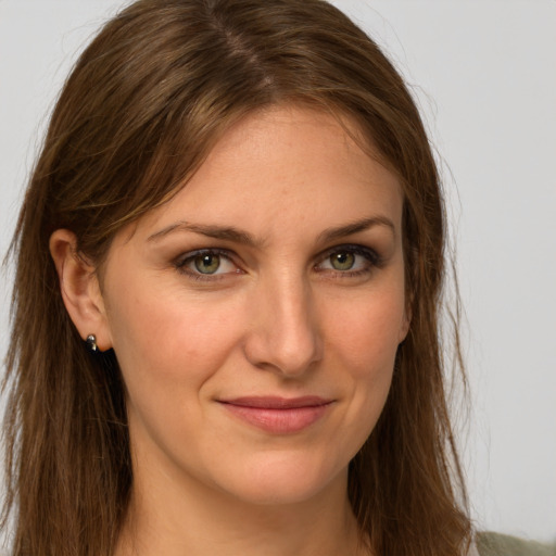 Joyful white young-adult female with long  brown hair and green eyes