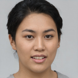 Joyful asian young-adult female with short  black hair and brown eyes