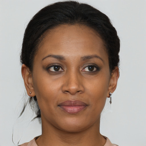 Joyful black young-adult female with short  brown hair and brown eyes