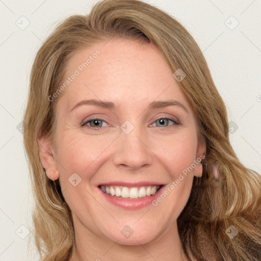 Joyful white adult female with long  brown hair and blue eyes