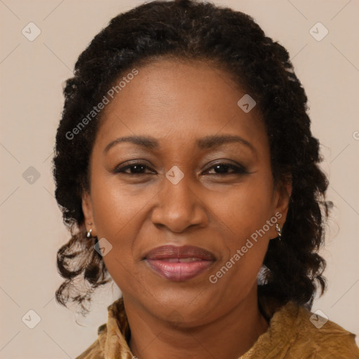 Joyful black adult female with long  brown hair and brown eyes