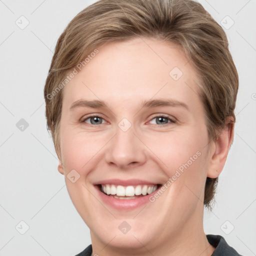 Joyful white young-adult female with short  brown hair and grey eyes